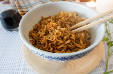 Oriental food, Chinese noodles, picked up with wooden chopsticks
