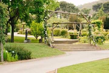 Wooden arches decorated with flowers in a Barcelona garden