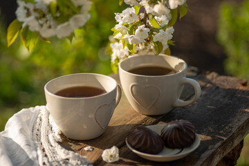 Coffee with milk, cocoa, tea in cups with heart decor, lace napkin on a wooden table. Cherry...