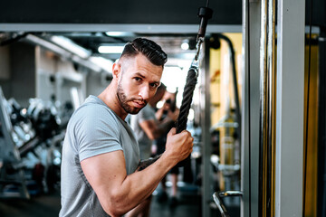 bodybuilding details and fitness workout. Man in sport gear working out at gym. Close up portrait.