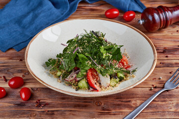 Fresh vegetable salad with nuts, wooden background