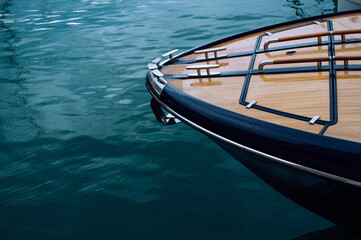 The front of a wooden yacht against the blue sea
