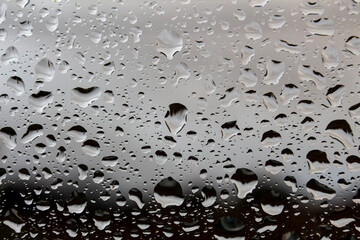 dark wet background, raindrops for overlaying on window, background of drops of water rain on glass transparent