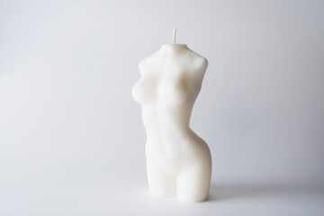 a candle in the form of a female body