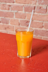 Refreshing fruit drink, red background