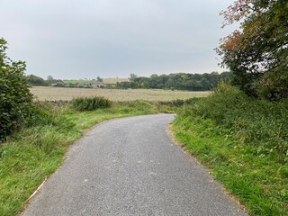 Rural landscape, from Cinder Lane, with fields, farms, and a cloudy sky in, Lindley, Otley, UK