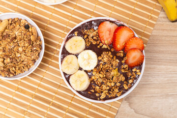 Close Up of açai bowl, with banana and strawberry. Top View