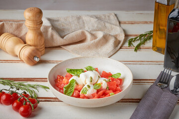 Caprese salad, wooden white background