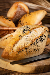 Fresh bread rolls on a rustic wooden table.