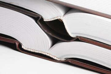 Close-up of the hardback of a thick book on a gray background. Reading and libraries