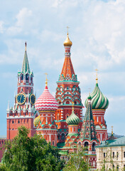 Fototapeta na wymiar Spasskaya Tower of Moscow Kremlin and the Cathedral of Vasily the Blessed (Saint Basil's Cathedral) on Red Square. Summer sunny day. Moscow. Russia