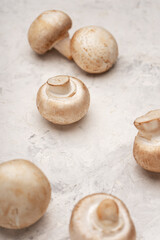 A few mushrooms on a light stone table