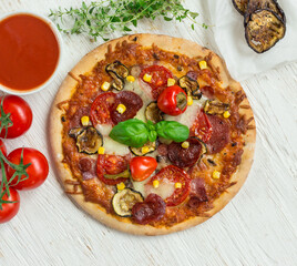 Delicious pizza with ingredients and spices on table, top view.