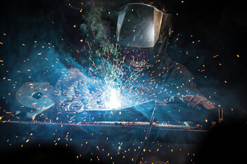 Fototapeta na wymiar worker with protective mask welding metal, close-up