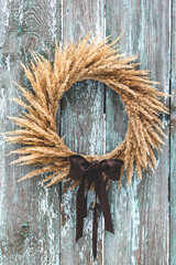 A wreath of dried flowers on a background of wooden boards. Vintage. Interior wreath. Dried flowers as an element of home decor