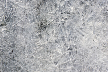 Close-up of a frozen water surface in winter. Beautiful frozen ice texture.