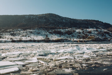 Beautiful calm landscape of the river. White ice floes float with the flow.