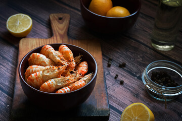 Greenlandic shrimps. Boiled shrimp on a dark background with lemon and spices.Preparation of a dietary dish . Protein products. Source of omega 3 and omega 6 acids.