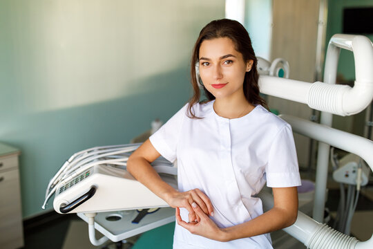 Image of a beautiful happy young woman doctor in medical dentist center.