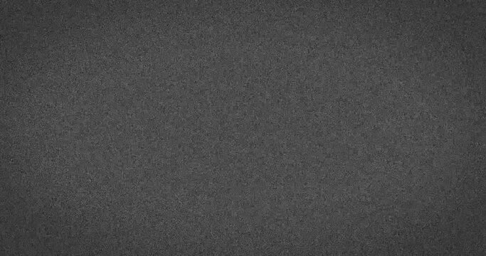 Animation of grey abstract noise specks moving fast on grey background