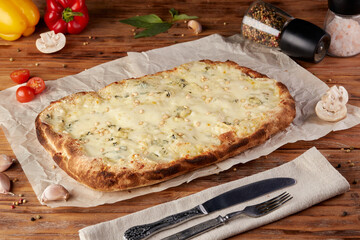 Roman pizza, variant of classic Italian pizza, wooden background