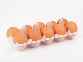 Fresh hen eggs in egg tray box on the white background