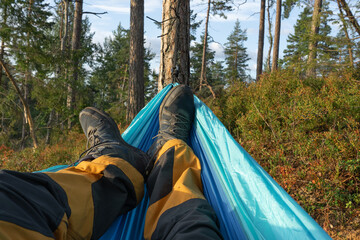 Man relaxing in the hammock after hicking.