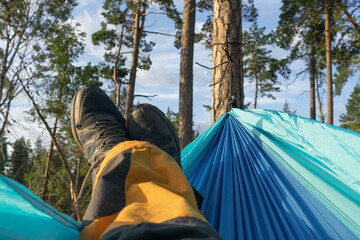 Person resting in the Hammock on the Nature.