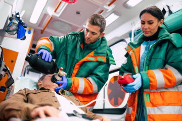 Unconscious senior man and working paramedics in the ambulance © My Ocean studio
