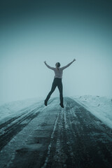 Backview of a girl hiking in the frozen mountain winter landscape. Harz National Park in Germany