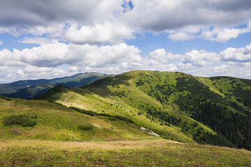 Fototapeta na wymiar View over the green coloured peaks of the Low Tatras