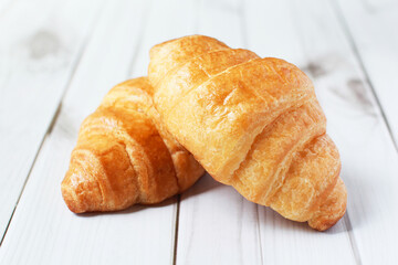 Fresh croissants on a white background,  Food and breakfast concept, puff pastry and biscuits on wooden table.