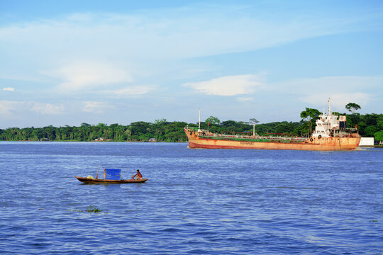 Small boats and cargo ships are going on the Kirtankhola river