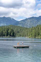 Tourists enjoy summer Eibsee lake activity in sunny day in Grainau Germany