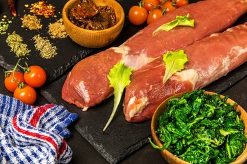 Pork tenderloin. Fresh raw meat prepared for cooking. Organic pork meat on chopping board ready for cooking, rustic style. Fresh raw pork tenderloin.