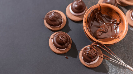 Homemade baking. Coating the pastry with melted chocolate.