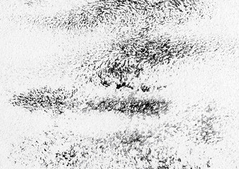 Black paint abstract art pattern on a white wall texture background