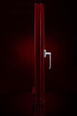 Red aluminium profile window on reflective glass on black background 