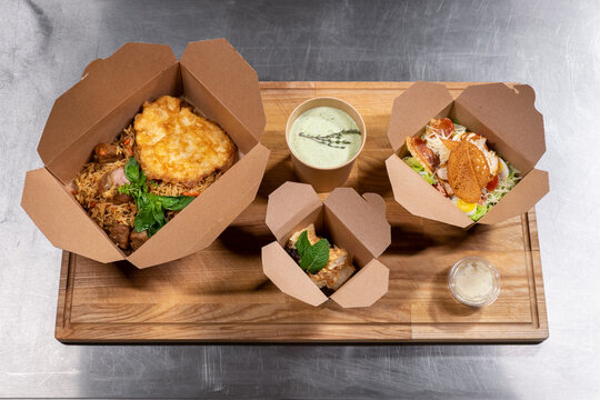 top view of kraft paper food containers with meal for delivery