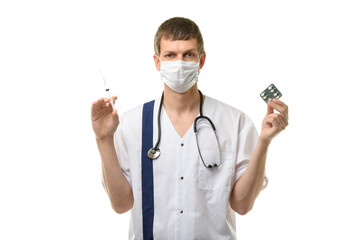 Male doctor holding a syringe with medicine in one hand and pills in the other hand, isolated on...