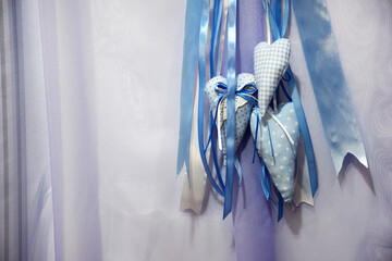 Сomposition of blue textiles hearts and antlas ribbons on purple organza background with copy space. background for newborn boys or Valentine's Day. Love hearts on textile texture background. 