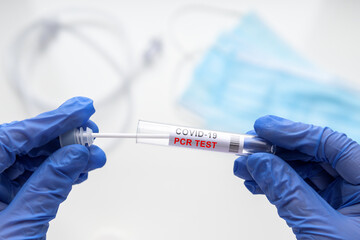 PCR test to COVID-19 in doctor hands, coronavirus swab collection kit in laboratory