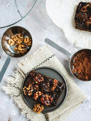 Chocolate hazelnut brownie. Classic American dessert. Piece of chocolate brownie with nuts and caramel close-up.