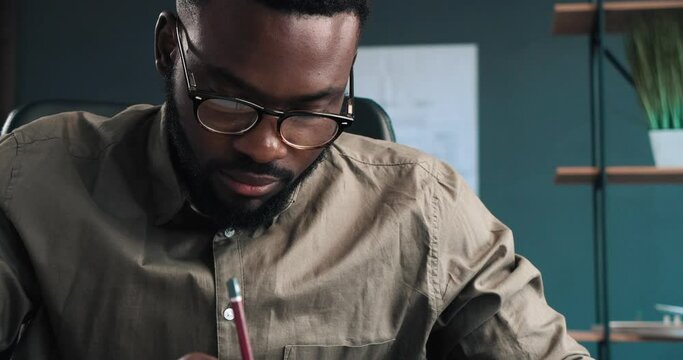 Close up of Architect Hands drawing blueprints in office. Engineer sketching a construction project. Architectural plan. Close-up portrait of handsome bearded man concentrated on work.Construction.