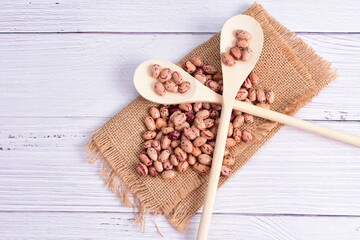 Natural bean grains, Phaseolus vulgaris on wooden background with light veins