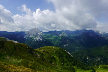 green hills in wonderful mountains with many clouds on the sky