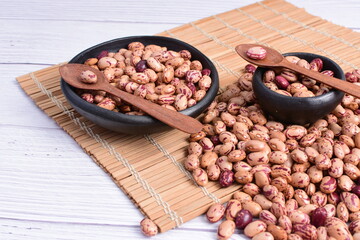 Natural bean grains, Phaseolus vulgaris on wooden background with light veins