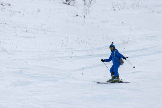 Skier skiing downhill in high mountain. Good winter day, ski season. Winter sport theme. Gusar- Azerbaijan.