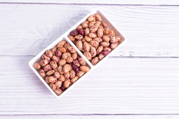 Natural bean grains, Phaseolus vulgaris on wooden background with light veins