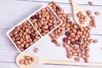 Natural bean grains, Phaseolus vulgaris on wooden background with light veins